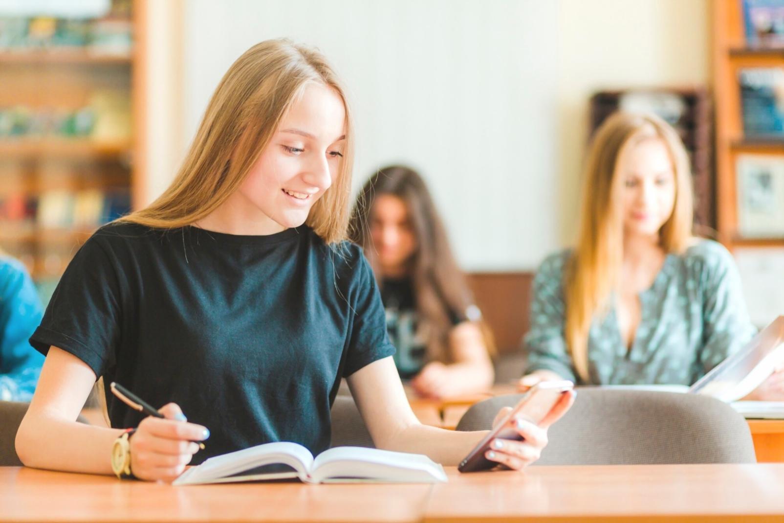 Students analyzing real market data and investment portfolios during practical learning session